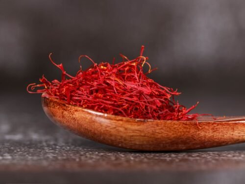 red saffron spice on brown wooden spoon