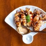 cooked squid on white ceramic plate