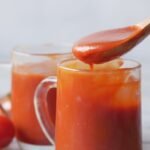 a spoon with tomato sauce
