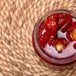 a close up shot of a jar of sun dried tomatoes