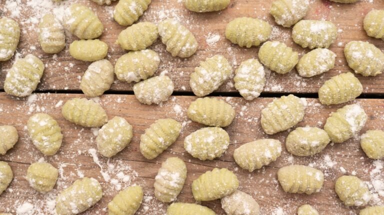 gnocchi with sprinkled flour on a wooden surface