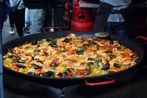 delicious paella with mollusks in big frying pan