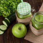 green apple beside of two clear glass jars