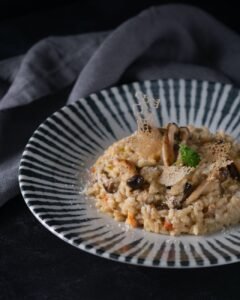 photo of risotto on a black and white plate