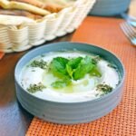white ceramic bowl with yogurt and mint leaves