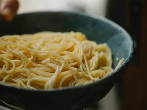 anonymous person demonstrating bowl with delicious spaghetti