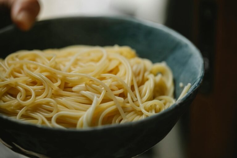 anonymous person demonstrating bowl with delicious spaghetti